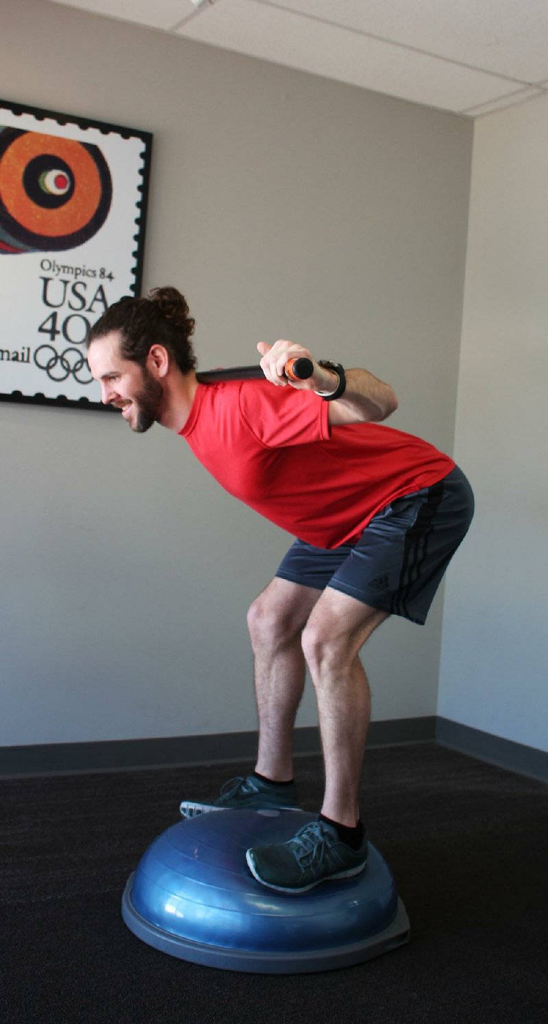 Arkansas Democrat-Gazette/CELIA STOREY
Eric Godwin does the 3rd step of the BOSU Good Morning exercise for Matt Parrott's Master Class column in ActiveStyle, at Little Rock Racquet Club.

