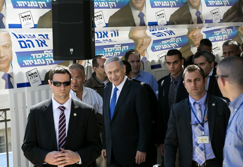 Israeli Prime Minister Benjamin Netanyahu, center, visits a construction site in Har Homa, east Jerusalem, Monday March 16, 2015, a day ahead of legislative elections. Netanyahu is seeking his fourth term as prime minister. 
