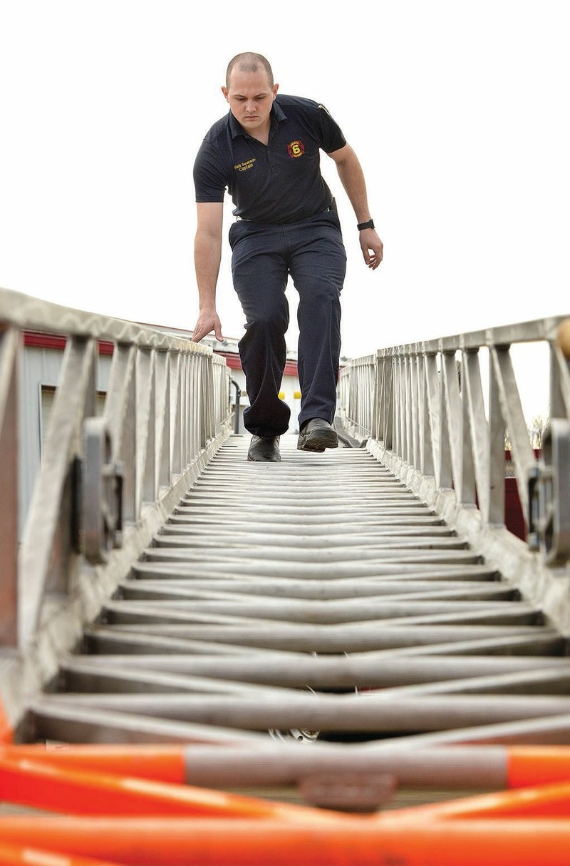 Matt Swanson, part-time captain with the Centerton Fire Department, performs a daily operations
check Thursday on Ladder 631 at Centerton Fire Station No. 1. For photo galleries, go to nwadg.
com/photos.