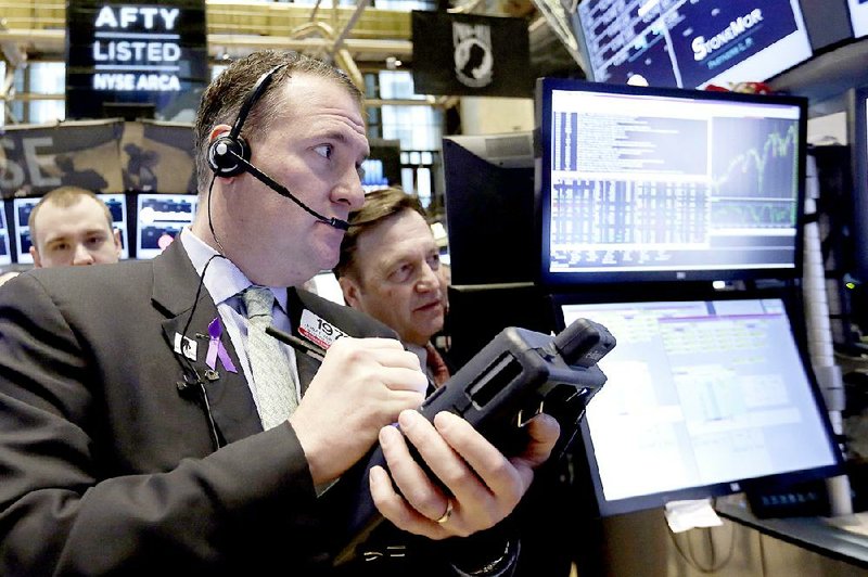 Trader Jonathan Corpina, left, works on the floor of the New York Stock Exchange, Monday, March 16, 2015. U.S. stocks opened higher, led by health care and utilities companies, rebounding after three weeks of losses. (AP Photo/Richard Drew)