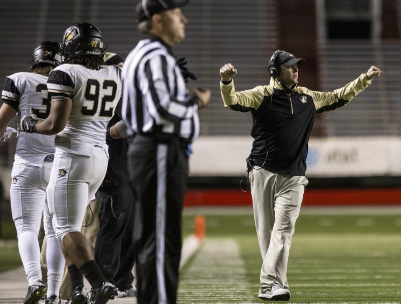 Arkansas Democrat-Gazette/MELISSA SUE GERRITS - 11/28/2014 - Bentonville defensive coordinator Jody Grant signals to his players during a Class 7A state playoff semifinal game against North Little Rock on Nov. 28 at War Memorial Stadium in Little Rock. Grant was named the Tigers&#8217; new head coach Monday.