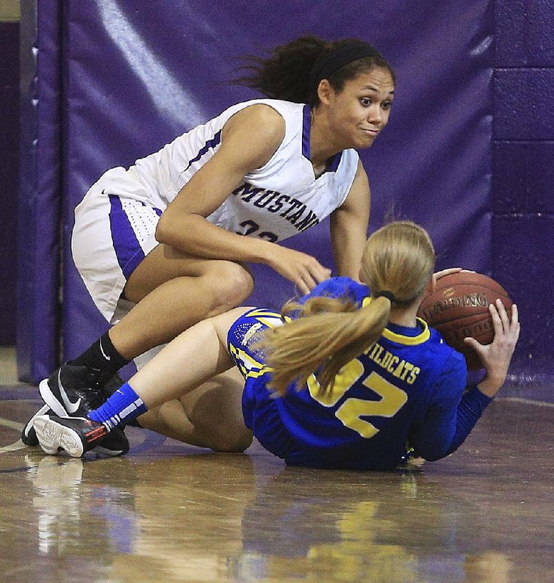 Sydnie Jones (left) of Central Arkansas Christian and Camdyn McDaniel of North Little Rock scramble for a loose ball during Team Farr’s 74-65 victory over Team Treadway on Tuesday in the All-Metro girls all-star game in Little Rock.