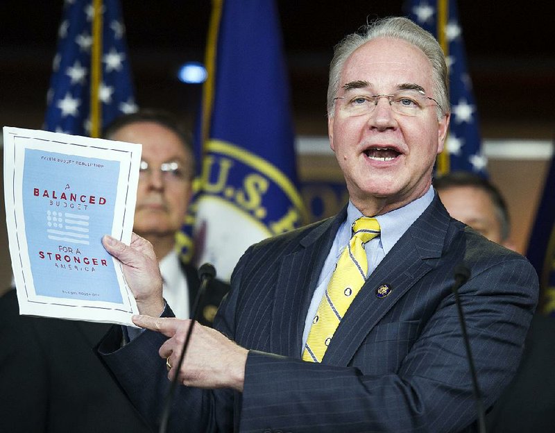 Rep. Tom Price, R-Ga., chairman of the House Budget Committee, displays a synopsis of the House Republicans’ 10-year budget plan Tuesday in Washington. The plan backs strong military spending, partial privatization of Medicare and deep cuts in other social programs with the aim of balancing the budget by the end of the decade.  