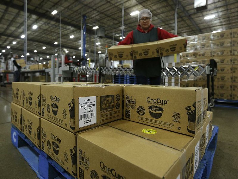 Gardenia Reynoso stacks boxes of coffee pods to be shipped from the Rogers Family Co. in Lincoln, Calif., earlier this month. The company makes single-serve pods for use in Keurig Green Mountain’s coffee machines. 