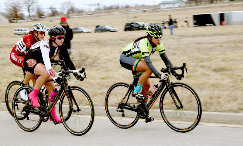 LYNN KUTTER ENTERPRISE-LEADER Flora Yan, with the University of Texas at Dallas, in the lead here, is the conference leader for South Central Collegiate Cycling Conference with USA Cycling. She won a criterium race recently when collegiate riders raced on a one-mile course held in Sundowner Estates subdivision in Prairie Grove. In her group are Ashley Weaver of Midwestern State University in Wichita Falls, Kan., in second, and Kathryn Brown from the University of Oklahoma in third. These students race in Women&#8217;s Class A, which is the top division for collegiate women.