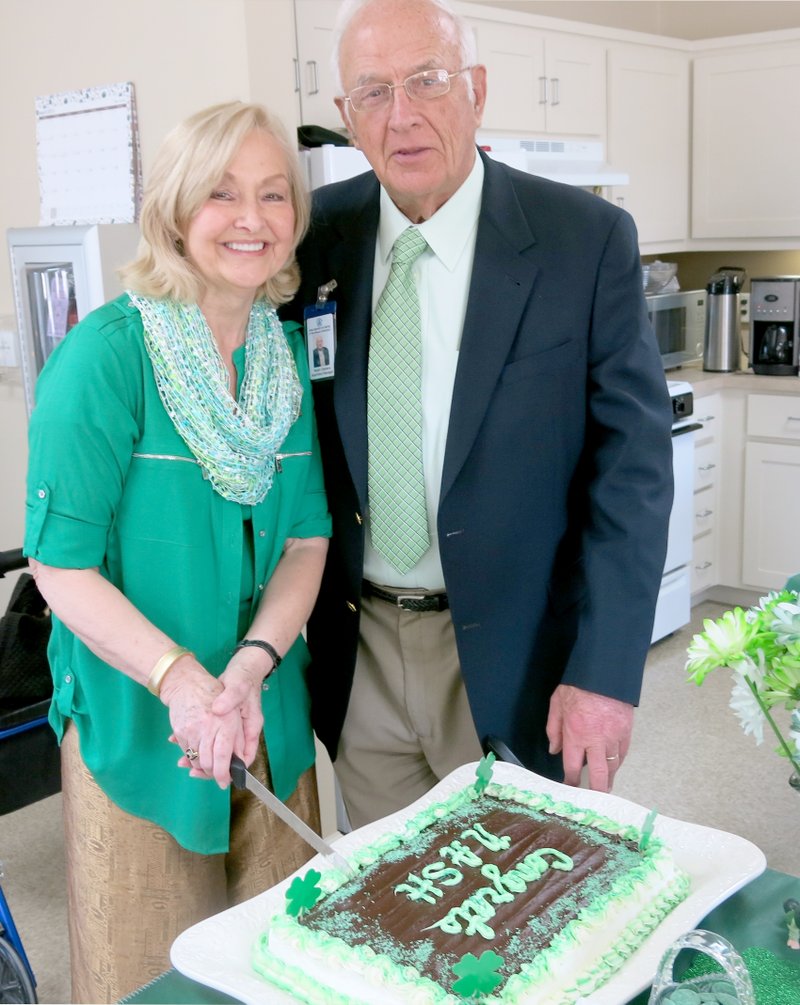 Photo by Susan Holland Ralph and Rita Clemans of Bella Vista cut the cake for the safe room open house last Thursday. Ralph is the apartment manager for the North Arkansas Senior Housing of Gravette complex.