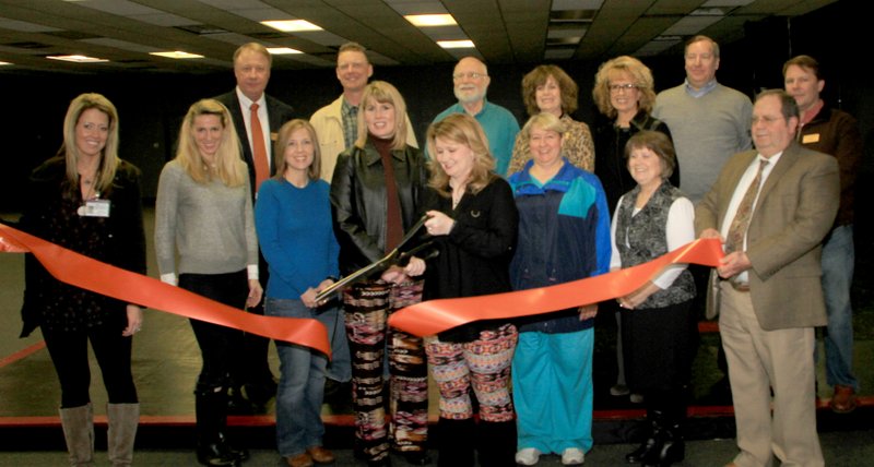 Photo by Steve Huckriede Several Gravette citizens, mostly members of Gravette Chamber of Commerce, were present for the ribbon cutting at Dynamic Rhythm Dance Studio Monday, March 9. Pictured here are Amanda Gittlein, Addie Johnson, Alisha Davis, Sundee Hendren, studio owner Jodi Moore, Julene Keller, Kathy Johnson, Chamber treasurer Rickie Stark, Richard Page (back, left), Eric Meyer, Chamber president Dan Yates, Cathy Crawford, Debbie Strickland, Rick Pollreis and Gravette mayor Kurt Maddox.