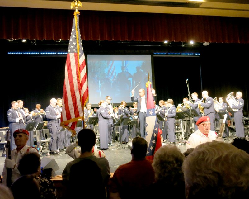 Photo by Susan Holland The U.S. Air Force Band of Mid America concert band, appearing Monday night at the Gravette High School Performing Arts Center, opened its performance with a rousing rendition of The Star Spangled Banner. Members of the Bella Vista Honor Guard Post #341 posted the colors as the audience stood and sang along.