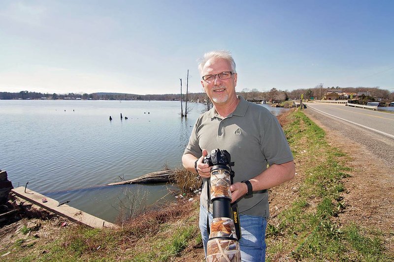 Jim Belote, a biology and chemistry teacher at St. Joseph Catholic School in Conway, holds his camera and stands along the shore of the Craig D. Campbell Lake Conway Reservoir in Mayflower where he first saw the long-tailed duck, an unusual bird for Arkansas. Belote said he is new to photography and birding. He had purchased an upgraded camera and telephoto lens just a couple of months before taking pictures of the duck. “I have never been what you could consider a birder, but I’m well on my way,” Belote said.