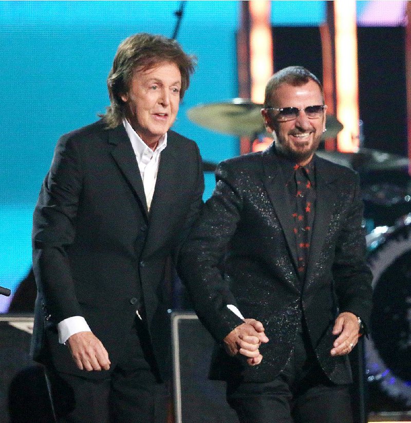 In this Jan. 26, 2014 file photo, Paul McCartney, left, and Ringo Starr appear at the 56th annual Grammy Awards in Los Angeles. McCartney will induct his former Beatle mate, Ringo Starr, into the Rock and Roll Hall of Fame next month. The 30th annual induction ceremony is scheduled for Cleveland's Public Hall on April 18.