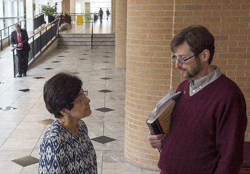 University of Arkansas at Little Rock Executive Vice Chancellor and Provost Zulma Toro speaks Wednesday with faculty senate President Andrew Wright during a UA System board of trustees meeting on the Little Rock campus. 