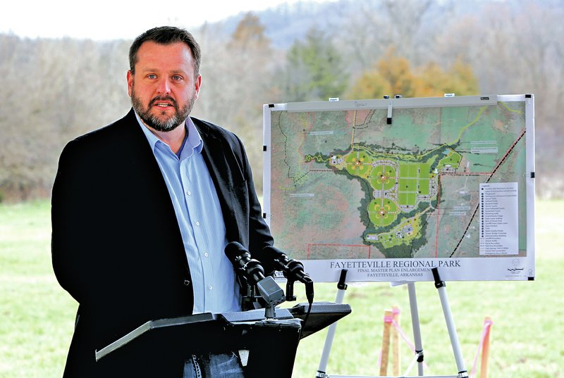 NWA Democrat-Gazette/DAVID GOTTSCHALK Ryan Hale, home region program officer with the Walton Family Foundation, speaks during the ground breaking. The City Council awarded a $9.4 million construction contract for phase I of the park to Crossland Construction earlier this month. For photo galleries, go to nwadg.com/photos.