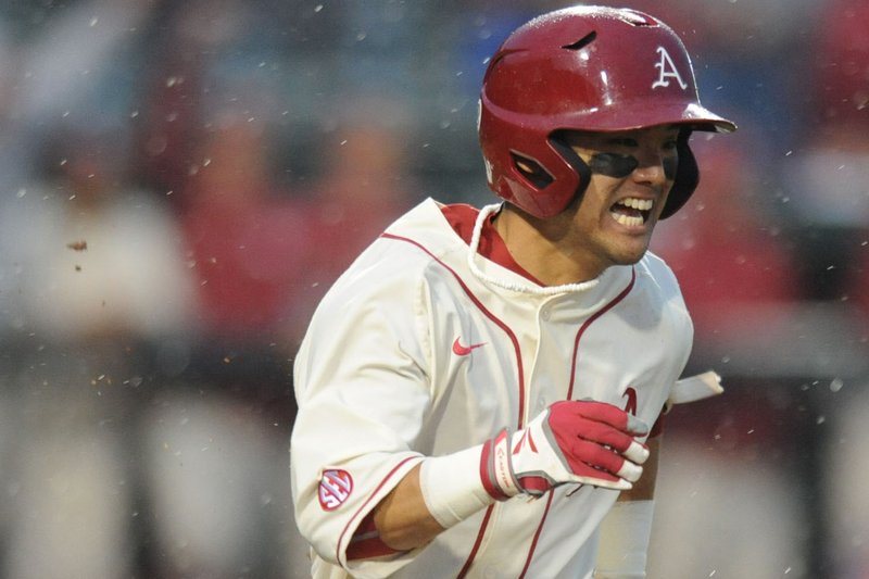 Rick Nomura of Arkansas heads to first against of LSU during the third inning Thursday, March 19, 2015, at Baum Stadium in Fayetteville.