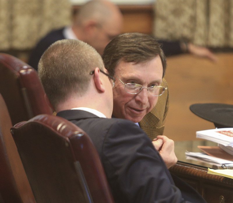 State Board of Education Chairman Sam Ledbetter (right) talks with Arkansas Department of Education attorney Jeremy Lasiter Thursday morning during a hearing at the Pulaski County Courthouse on a lawsuit challenging the state's decision to take over the Little Rock School District.