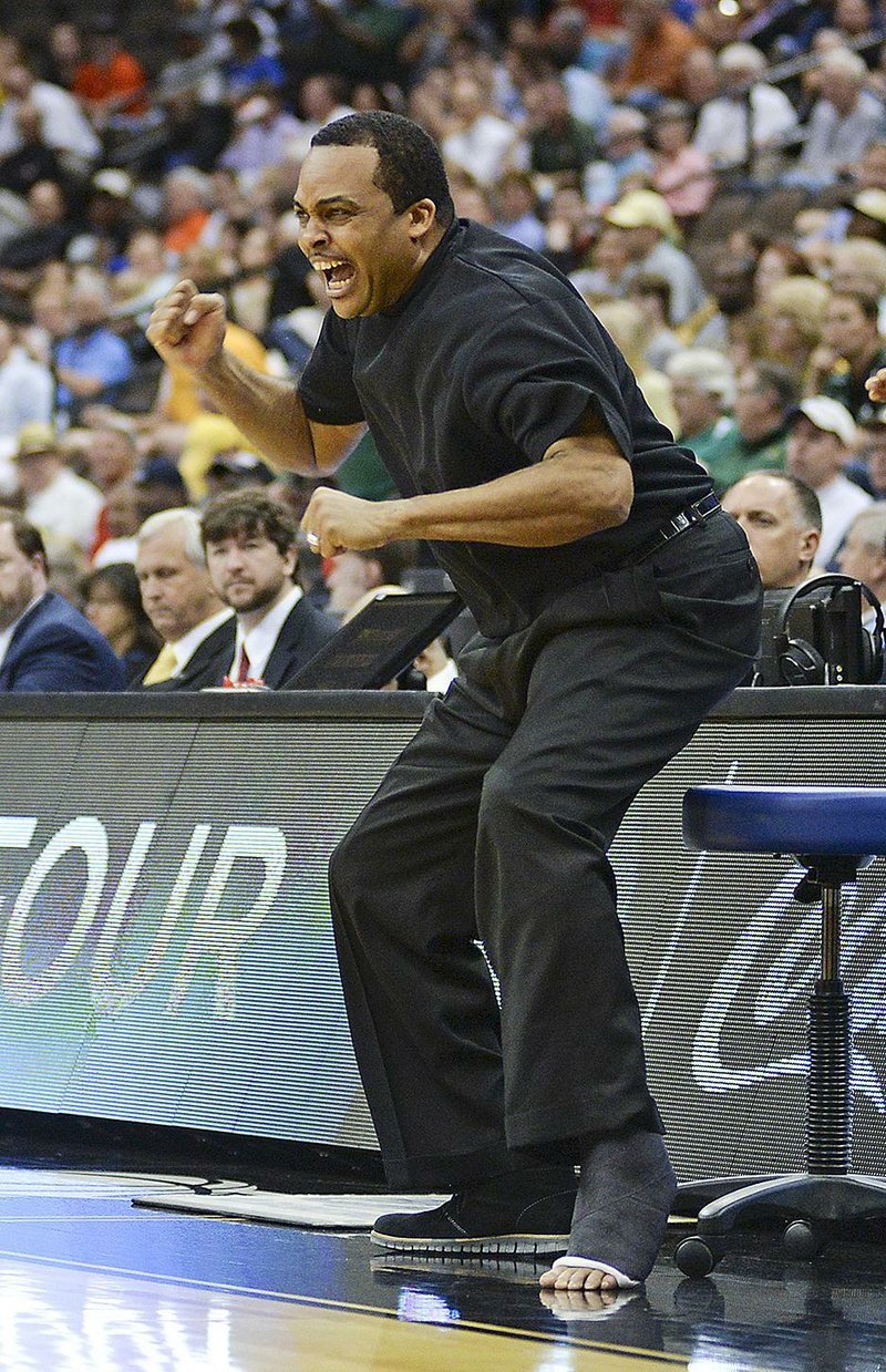 Georgia State Coach Ron Hunter, in a cast after tearing his Achilles’ tendon while celebrating the Panthers’ victory in the Sun Belt Tournament championship game last Sunday, cheers his players during the second half of Thursday’s NCAA Tournament opener against Baylor in Jacksonville, Fla. Not long after, Hunter found himself on the floor after falling off his rolling stool when his son, R.J., made a long three-pointer to knock off the Bears.