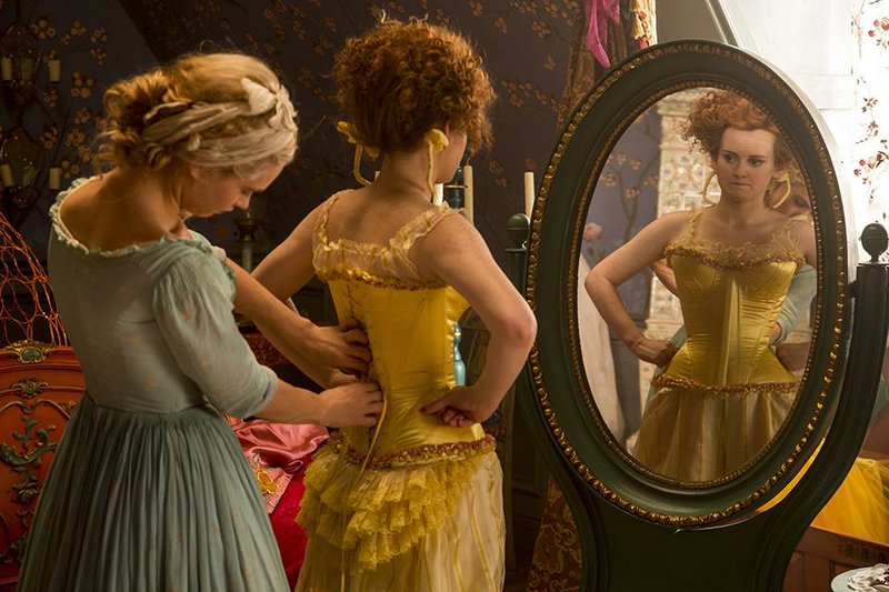 Lily James (left) is Cinderella and Sophie McShera is Drisella in Disney’s live-action feature Cinderella. It came in first at last weekend’s box office and made about $68 million.