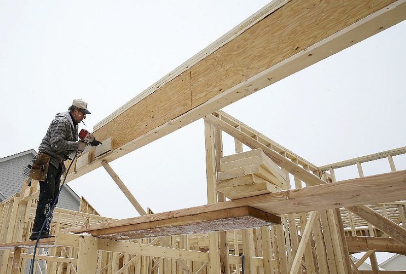 Builder Janez Bratkovic works on a new house last month in Pepper Pike, Ohio. The Conference Board’s measure of the economic outlook for the next three to six months rose 0.2 percent in February. 