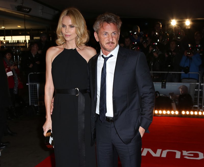  In this Feb. 16, 2015 file photo, actors Sean Penn, right, and Charlize Theron arrive for the World Premiere of "The Gunman" at the BFI south bank cinema, in London. Penn surfs, shoots, sprints, punches and fights for his life in the geopolitical thriller in theaters on Friday, March 20, 2015.