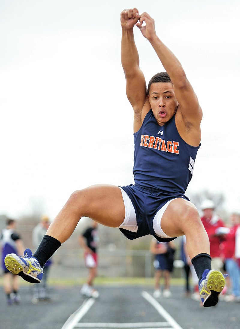 NWA Democrat-Gazette/JASON IVESTER Joey Saucier, Rogers Heritage senior, competes in the long jump Thursday at the Tiger Relays in Bentonville.
