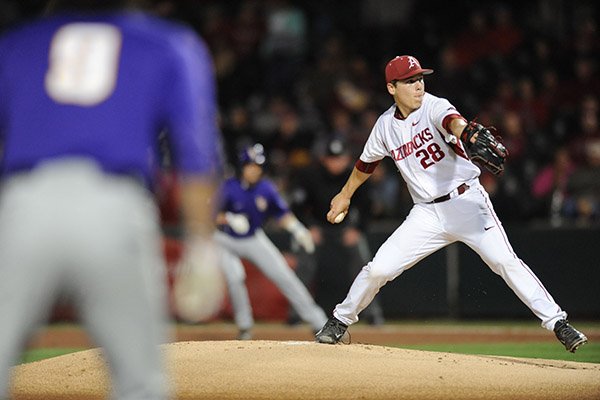 Starter James Teague of Arkansas delivers against LSU with runners on base during the first inning Friday, March 20, 2015, at Baum Stadium in Fayetteville. 