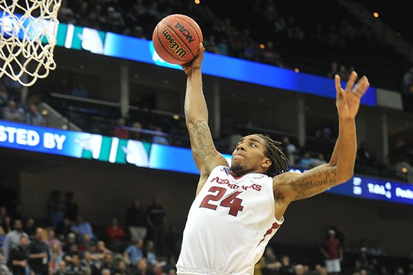 Arkansas guard Michael Qualls dunks the basketball during an NCAA Tournament game against Wofford on Thursday, March 19, 2015, at Veterans Memorial Arena in Jacksonville, Fla. 