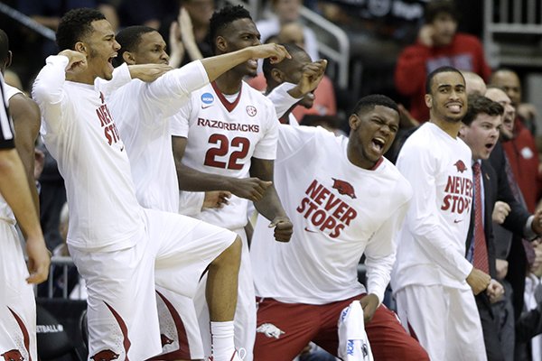 The Arkansas bench celebrates their 56-53 win over Wofford during an NCAA tournament second round college basketball game Friday, March 20, 2015, in Jacksonville, Fla. (AP Photo/John Raoux)