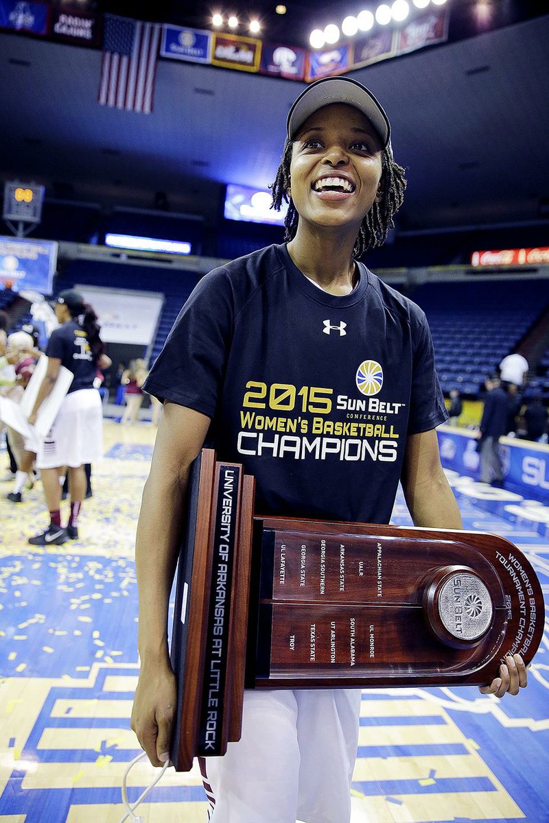 Arkansas Little Rock guard Taylor Gault (24) walks off the court with the championship trophy at the end of an NCAA college basketball game against Arkansas State in the championship of the Sunbelt Conference tournament in New Orleans, Saturday, March 14, 2015. Arkansas Little Rock defeated Arkansas State 78-72 for the title. (AP Photo/Bill Haber)