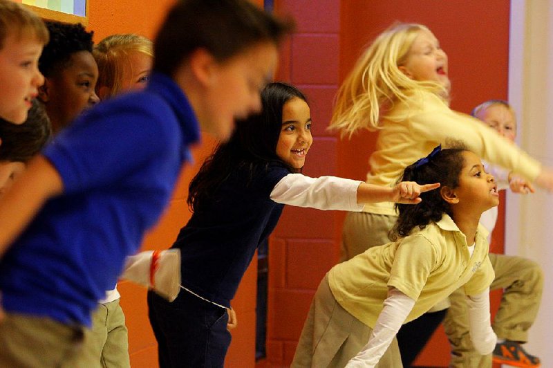 2/19/15
Arkansas Democrat-Gazette/STEPHEN B. THORNTON
Students including Caroline Ferguson, 6, center, and Kenlyee Ferguson, 5, bottom right, perform a skit during an acting class Thursday at the Little Rock School of the Arts in Little Rock. 

