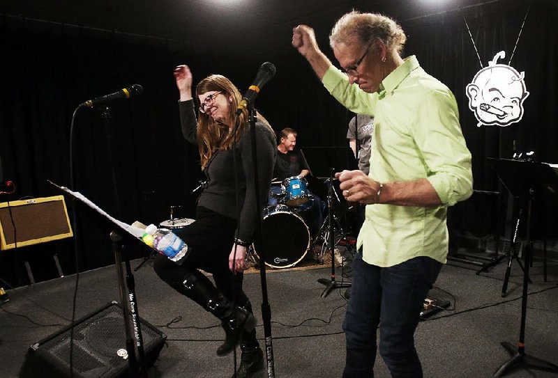 In this Jan. 29,2015 photo, Mark and Kathleen Stoehr, center front, practice as they fronted a Fleetwood Mac band at Rock Camp for Dads in St. Louis Park, Minn. Since 2009, Rock Camp has given hundreds of dads _ and moms, too _ an outlet for their rock star ambitions. Campers rehearse for a month at one of 10 camps devoted to Bruce Springsteen, Fleetwood Mac or other stars before taking the stage for a live gig. (AP Photo/Jim Mone) 