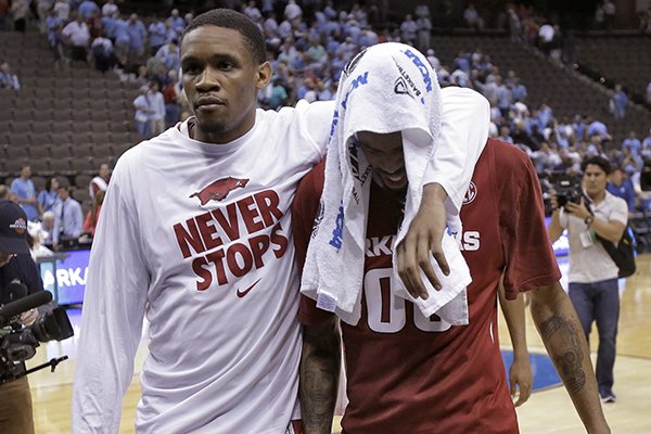 Arkansas guard Rashad Madden, right, and forward Keaton Miles leave the court after the team lost to North Carolina 87-78 during an NCAA tournament third round basketball game Saturday, March 21, 2015, in Jacksonville, Fla. (AP Photo/John Raoux)