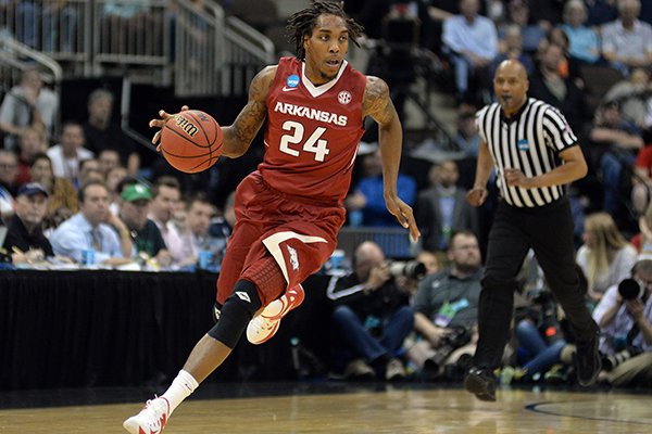 Arkansas guard Michael Qualls (24) drives up the court against North Carolina during the first half of an NCAA tournament third round basketball game Saturday, March 21, 2015, in Jacksonville, Fla. (AP Photo/Rick Wilson)