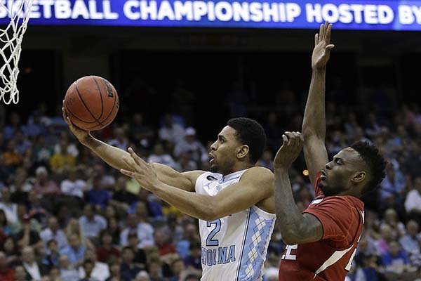 North Carolina guard Joel Berry II (2) beats Arkansas forward Jacorey Williams (22) to the basket on a layup during the first half of an NCAA tournament third round basketball game Saturday, March 21, 2015, in Jacksonville, Fla. (AP Photo/John Raoux)
