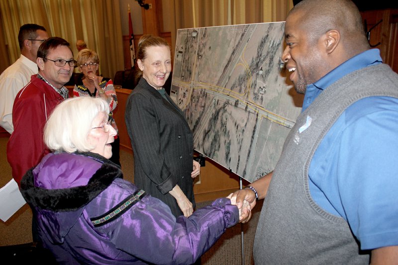 Tina Parker/Siloam Sunday Community Services Director Don Clark, right, greeted Dina Espinosa at Tuesday&#8217;s board meeting. Espinosa and her friend Sue Klopfenstein were at the meeting to see what option the city would select for the Cheri Whitlock Drive railroad overpass.