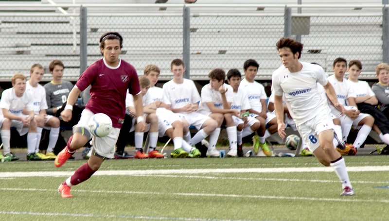 Photo courtesy of The Saline Courier Siloam Springs junior forward Aldair Umana, left, goes after a ball with a Bryant player in pursuit. The Panthers lost to the Hornets 1-0 to fall to 0-3 on the 2015 season.