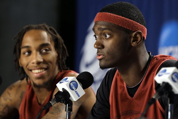 Arkansas's Bobby Portis, right, speaks as teammate Michael Qualls looks on, during a news conference at the NCAA college basketball tournament, Friday, March 20, 2015, in Jacksonville, Fla. Arkansas takes on North Carolina in the Round of 32 on Saturday. (AP Photo/Chris O'Meara)