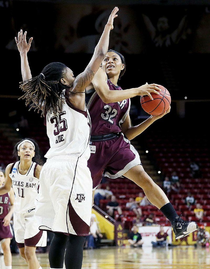 Arkansas Little Rock guard Ka'Nesheia Cobbins (32) shoots over Texas A&M forward Achiri Ade (35) during the second half of a women's first round NCAA tournament college basketball game, Saturday, March 21, 2015, Tempe, Ariz. Arkansas Little Rock won 69-60. (AP Photo/Matt York)