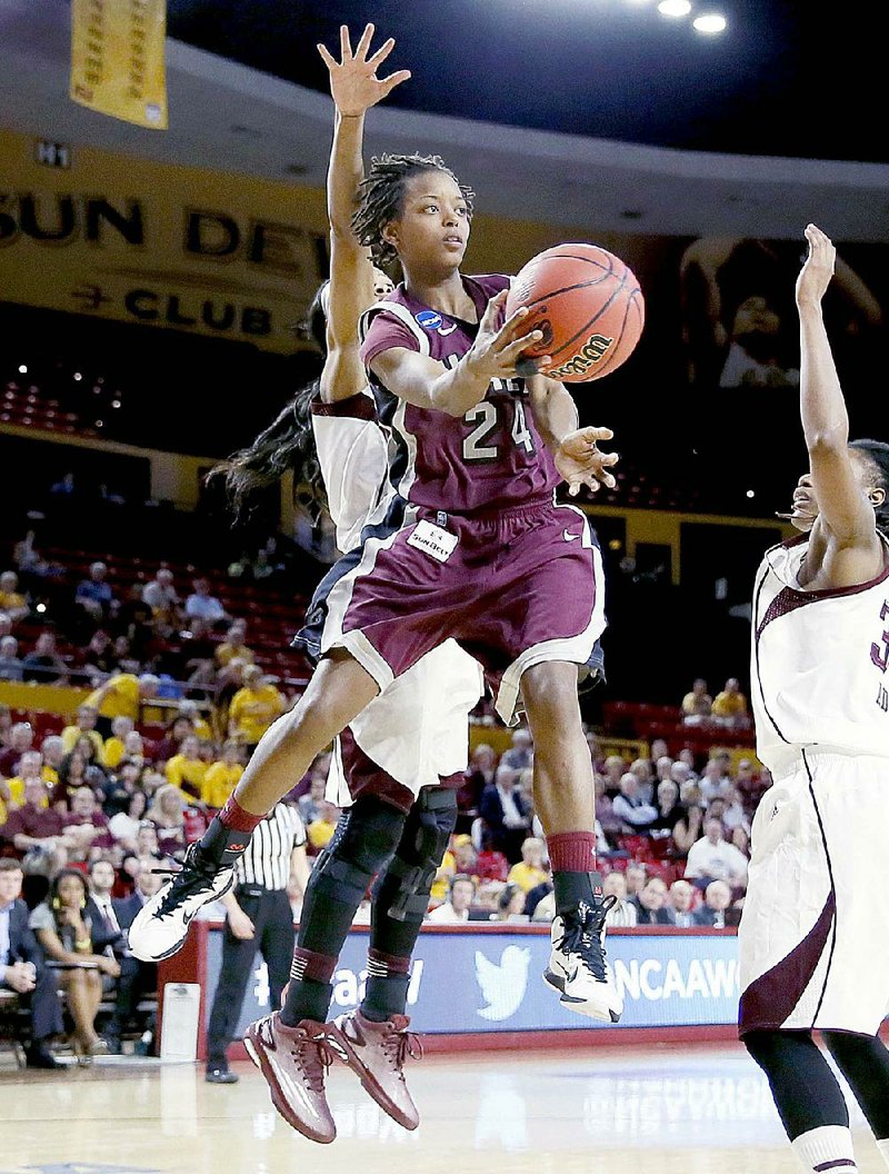 Arkansas Little Rock guard Taylor Gault (24) dishes off against Texas A&M during the second half of a women's first round NCAA tournament college basketball game, Saturday, March 21, 2015, Tempe, Ariz. Arkansas Little Rock won 69-60. (AP Photo/Matt York)