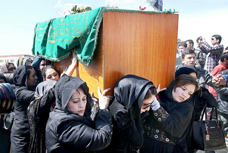 Afghan women rights activists carry the coffin of 27-year-old Farkhunda, an Afghan woman who was beaten to death by a mob, during her funeral, in Kabul, Afghanistan, Sunday, March 22, 2015. Hundreds of people gathered in northern Kabul for the funeral of Farkhunda, who like many Afghans is known by only one name. She was killed late Thursday by a mob of mostly men who beat her, set her body on fire and then threw it into the Kabul River, according to police accounts. Police are still investigating what prompted the mob assault. (AP Photo/Massoud Hossaini)