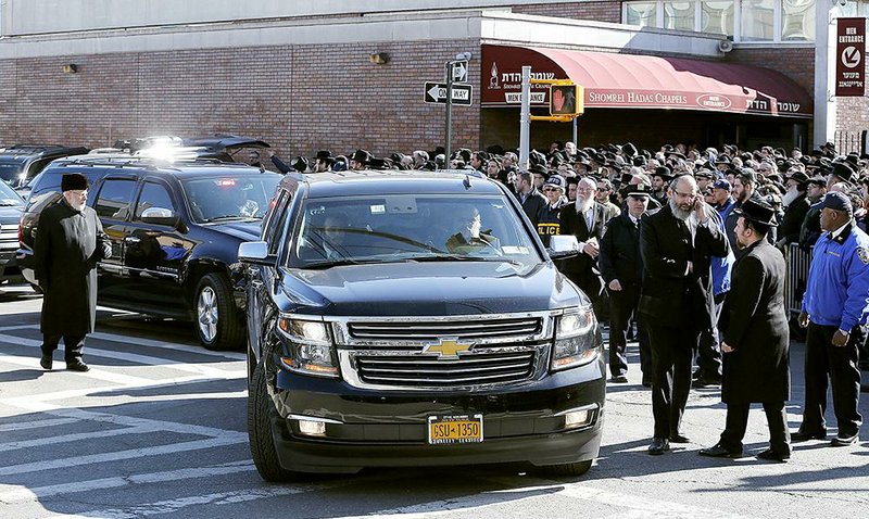Vehicles containing the remains of the seven siblings who died in a house fire leaves Shomrei Hadas Chapels following funeral services, Sunday, March 22, 2015, in the Brooklyn borough of New York. The siblings, ages 5 to 16, died early Saturday when flames engulfed the Sassoon family home in the Midwood neighborhood of Brooklyn. Investigators believe a hot plate left on a kitchen counter set off the fire that trapped the children and badly injured their mother and another sibling. (AP Photo/Julio Cortez)