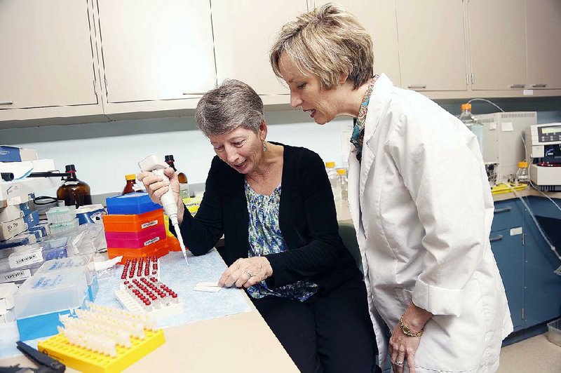 Special to the Arkansas Democrat-Gazette - 03/20/2015 - Dr. Laura James (right), professor of pediatrics at the University of Arkansas for Medical Sciences, and Lynda Letzig (left), a research fellow in the pediatrics department at UAMS, discusses a newly developed test that determines if liver damage is caused by acetaminophen overuse.