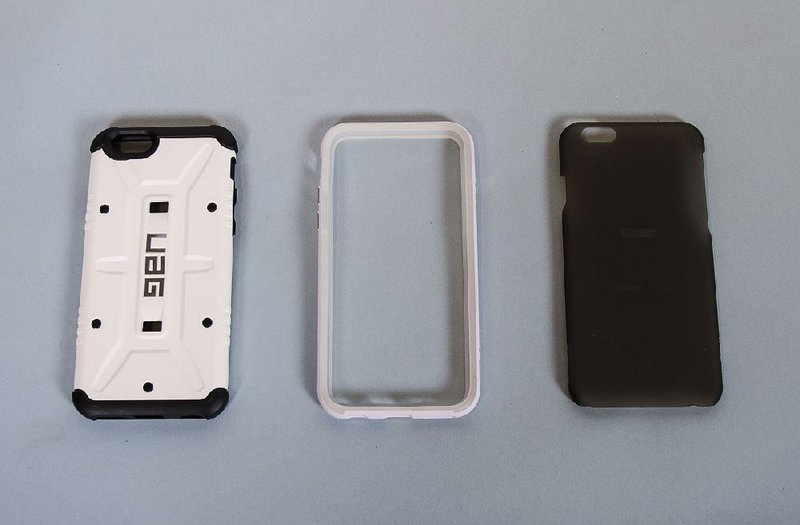 Special to the Democrat-Gazette/MELISSA L. JONES
The Urban Armor Gear Navigator (left) case provides protection that can even handle the extremes of space, while the Bezel (center) provides more protection than expected from a bumper case. The Slim keeps a low profile, but at a cost.