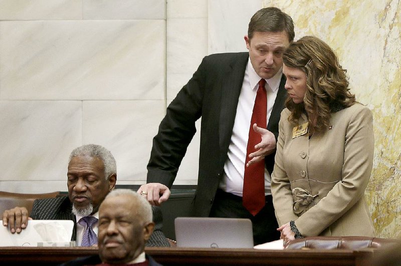 Arkansas House Speaker Rep. Jeremy Gillam, R-Judsonia, center, speaks with Michelle Gray, R-Melbourne, right, in the House chamber at the Arkansas state Capitol in Little Rock, Ark., Monday, March 23, 2015. (AP Photo/Danny Johnston)