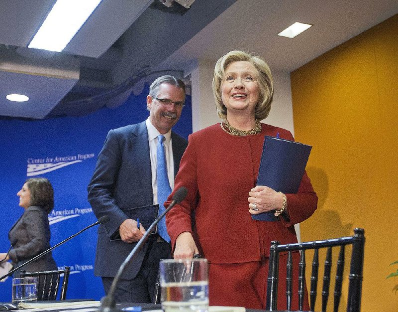 Former Secretary of State Hillary Rodham Clinton and Glenn Hutchins, left, Co-founder, Silver Lake, walk off stage after both speaking at an event hosted by the Center for American Progress (CAP) and the America Federation of State, County and Municipal Employees (AFSCME), in Washington, Monday, March 23, 2015. (AP Photo/Pablo Martinez Monsivais)