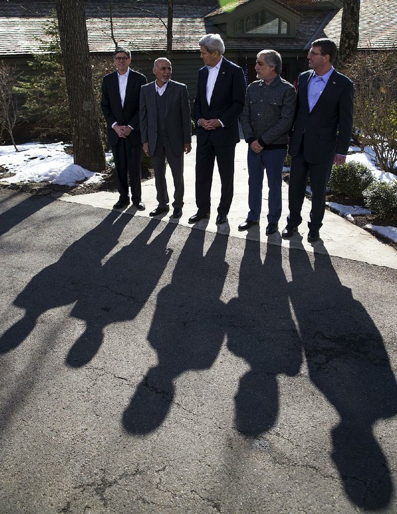 Secretary of State John Kerry, center, speaks before the start of meetings at the Camp David Presidential retreat, Monday, March 23, 2015, in Camp David, Md. The pace of U.S. troop withdrawals from Afghanistan will headline Afghan President Ashraf Ghani's visit to Washington, yet America's exit from the war remains tightly hinged to the abilities of the Afghan forces that face a tough fight against insurgents this spring. From left are, Treasury Secretary Jacob Lew, Afghanistan's President Ashraf Ghani, Kerry, Afghanistan's Chief Executive Abdullah Abdullah, and Defense Secretary Ash Carter. (AP Photo/ Evan Vucci)