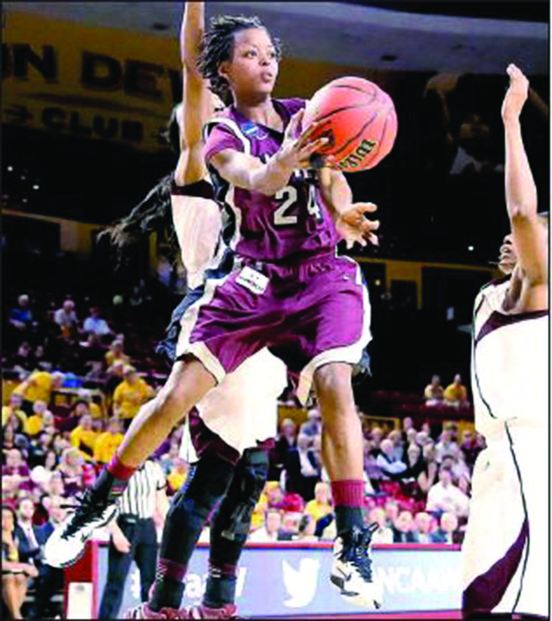 Lady Trojans fall in second round
UALR guard Taylor Gault (24) passes to a teammate during an earlier game in the NCAA tournament. On Monday, the Lady Trojans were eliminated from postseason with a 57-54 loss to Arizona State..