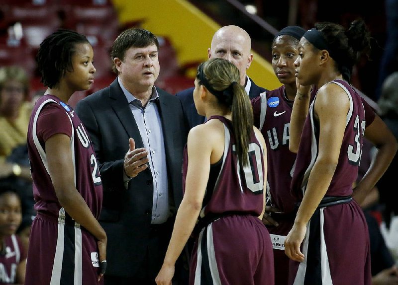 UALR Coach Joe Foley (center) said the Trojans’ effort against Texas A&M and Arizona State in the NCAA Women’s Tournament proved the program has staying power.