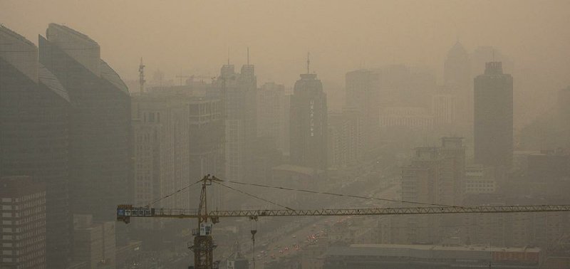 Pollution obscures the Beijing skyline in this 2008 fi le photo. The city plans to replace its coal power plants with gas-fired stations.