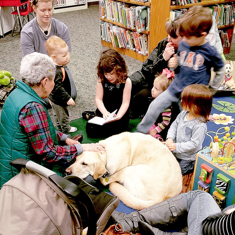 Submitted Jillian Grau reads to Dwayne the library dog.