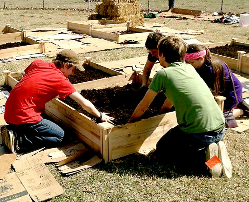 COURTESY PHOTO Students with EAST Lab class at Prairie Grove Middle School work on a new community garden in front of the elementary school, across from Prairie Grove Senior Activity and Wellness Center. The garden will provide fresh produce for school lunches and the center&#8217;s Meals on Wheels program.