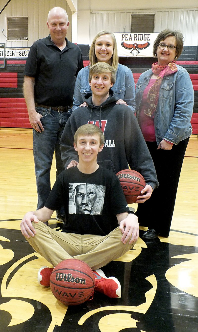 TIMES photograph by Annette Beard Joey Hall, seated, has a strong heritage of basketball with his family &#8212; elder brother, Jacob, sister, Jessica, and parents, Kevin and Ronda.